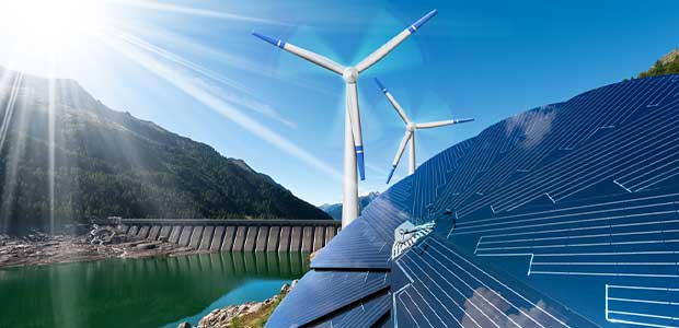 sun shining down on lake with dam. to the right of the lake are windmills, and to the right of those are solar panels