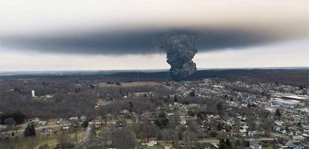 view of town skyline with black cloud reaching from town to sky
